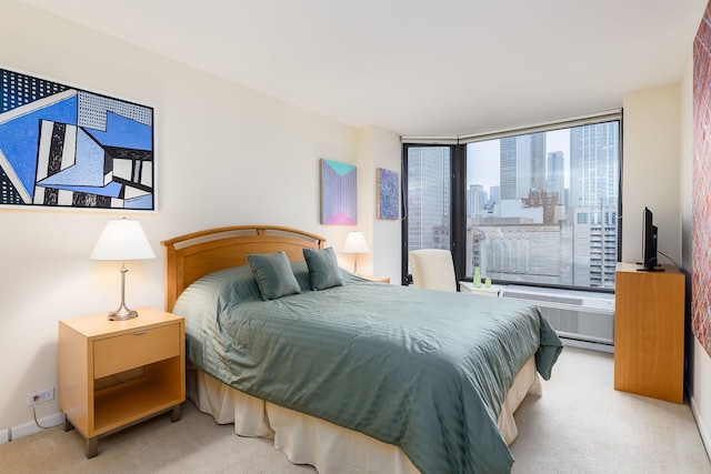 bedroom featuring carpet, a wall mounted AC, and baseboards