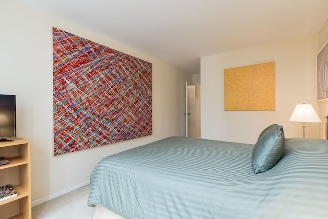 carpeted bedroom featuring baseboards