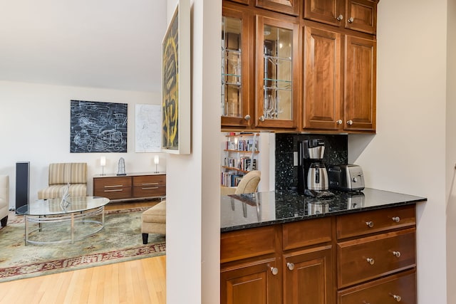 bar area with wood finished floors and decorative backsplash