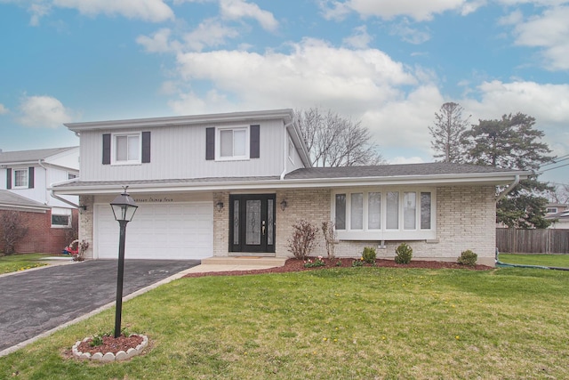 view of front of property with a front lawn, fence, brick siding, an attached garage, and aphalt driveway