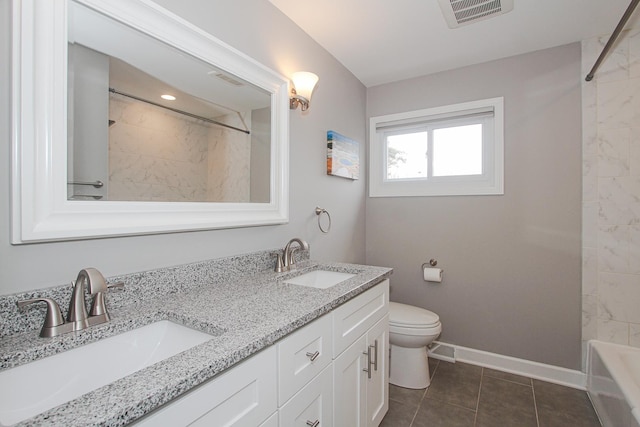 bathroom with visible vents, toilet, baseboards, and a sink
