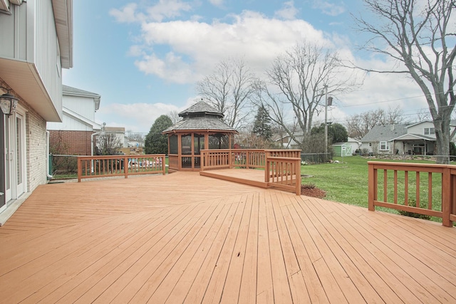 deck featuring a gazebo and a yard