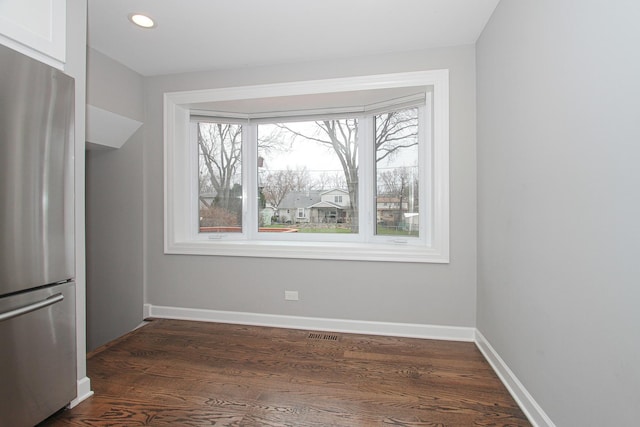interior space with visible vents, baseboards, dark wood-style floors, and recessed lighting