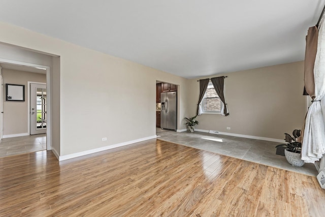 439 N Highview Ave, Elmhurst, IL 60126 - unfurnished living room with light wood-type flooring, baseboards, and a wealth of natural light