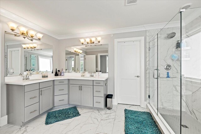 full bath featuring marble finish floor, an inviting chandelier, double vanity, ornamental molding, and a marble finish shower
