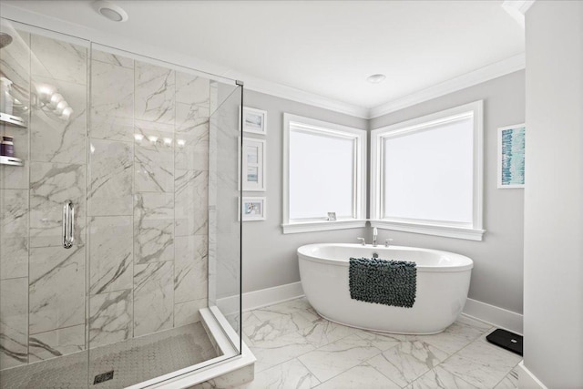 bathroom with marble finish floor, crown molding, baseboards, a soaking tub, and a stall shower