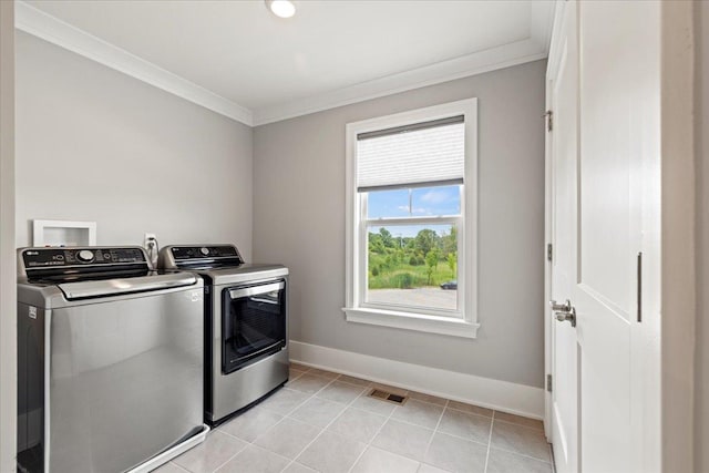 laundry room with ornamental molding, washer and clothes dryer, laundry area, and visible vents