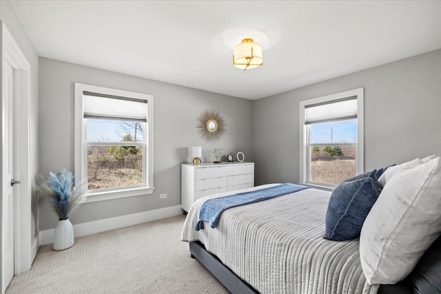 carpeted bedroom featuring baseboards