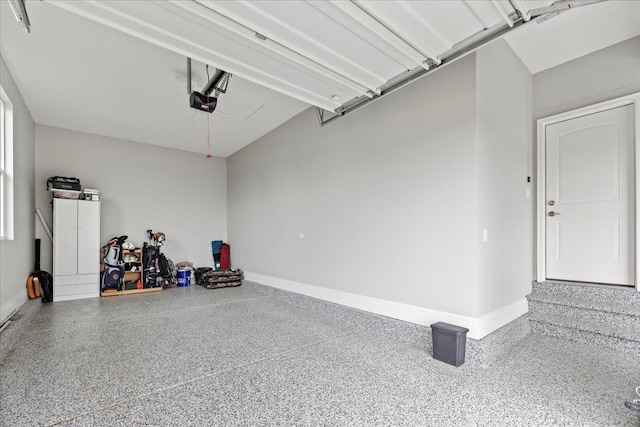 garage featuring baseboards and a garage door opener