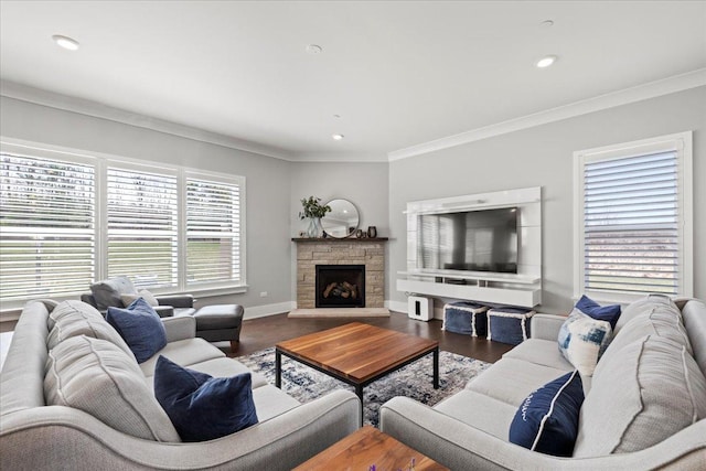 living area featuring a stone fireplace, wood finished floors, baseboards, ornamental molding, and recessed lighting