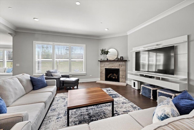 living area featuring a fireplace, wood finished floors, a wealth of natural light, and ornamental molding
