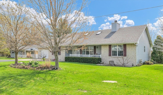view of front of home featuring a front lawn, brick siding, a porch, and a chimney