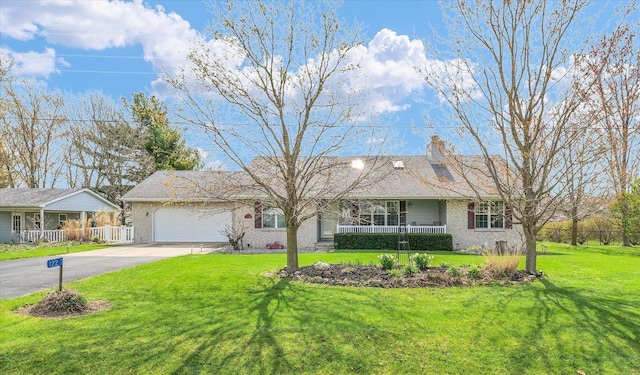 ranch-style house with fence, a front lawn, concrete driveway, an attached garage, and a porch