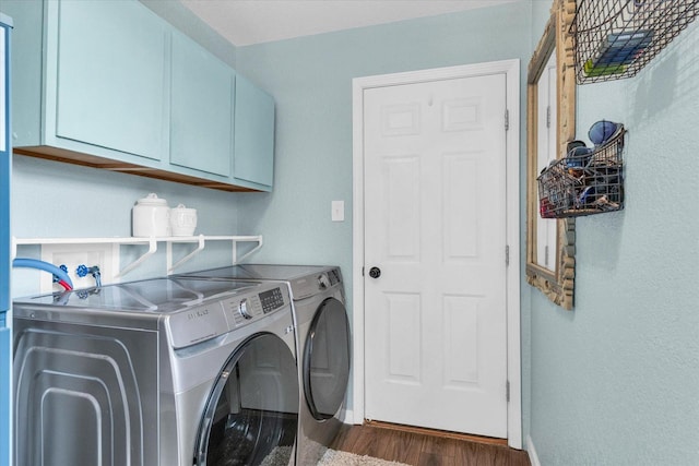 washroom featuring baseboards, cabinet space, dark wood-style floors, and independent washer and dryer