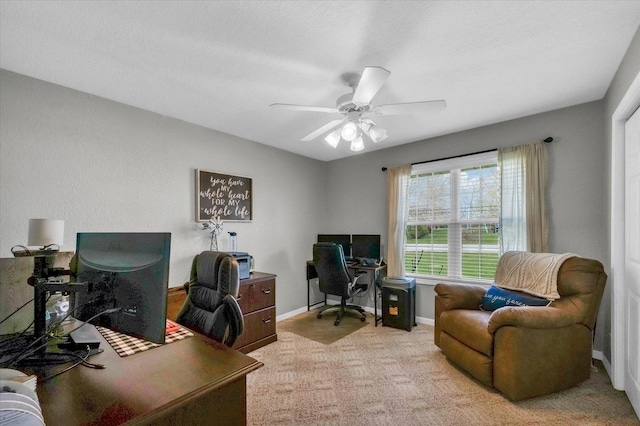 office space with carpet flooring, baseboards, and a ceiling fan
