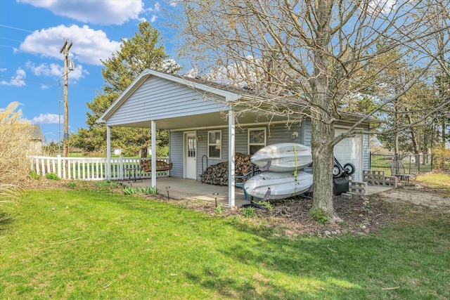 exterior space featuring a front lawn and fence