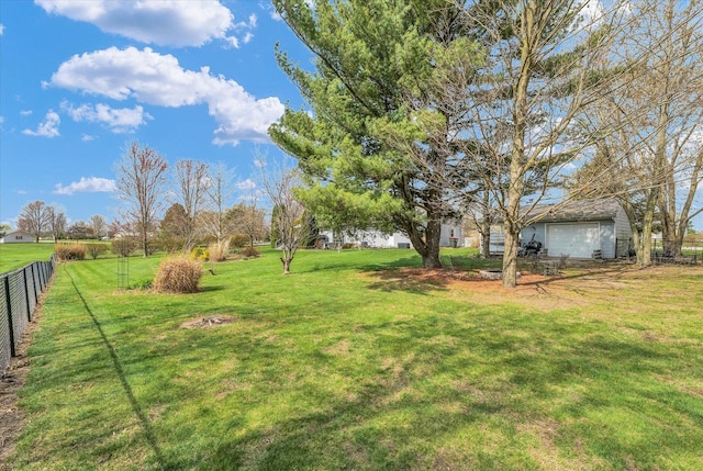 view of yard with fence and a garage