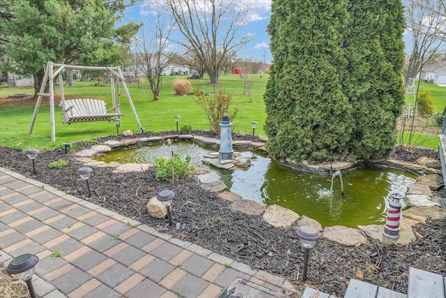 view of yard with a small pond
