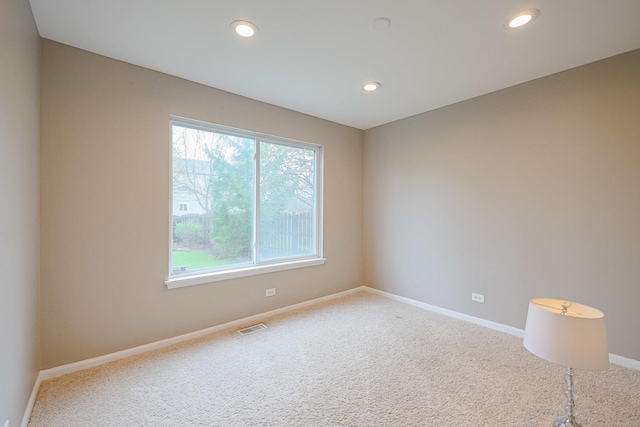 carpeted empty room featuring visible vents, recessed lighting, and baseboards