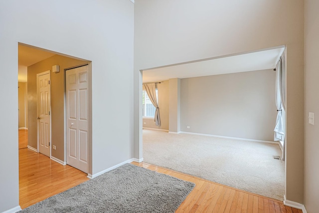 empty room featuring wood finished floors and baseboards