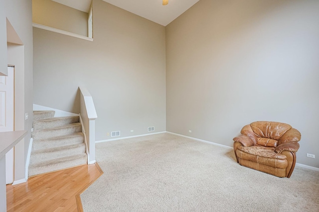 unfurnished room featuring stairs, visible vents, carpet floors, and baseboards