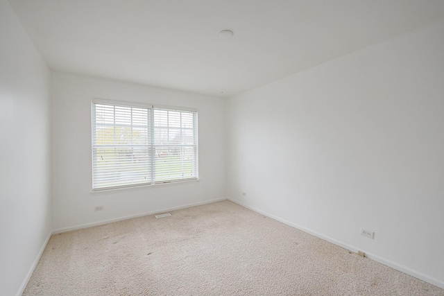 unfurnished room featuring baseboards and carpet floors