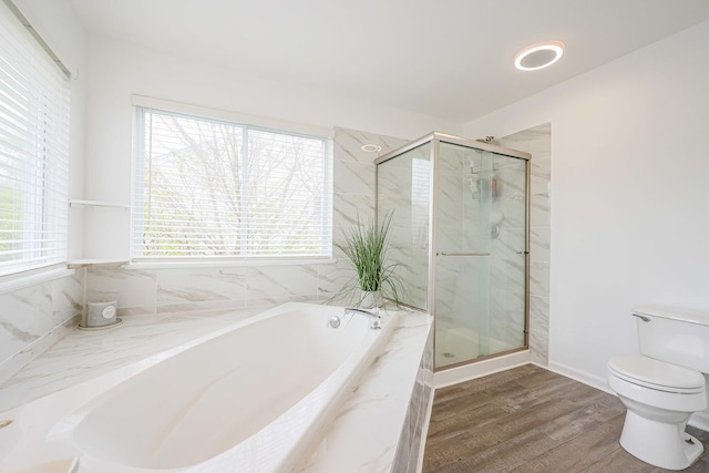 bathroom featuring wood finished floors, toilet, a bath, and a marble finish shower