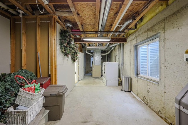 below grade area with heating unit and washer / clothes dryer