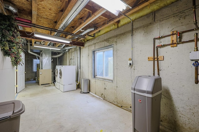 basement with heating unit and washing machine and dryer