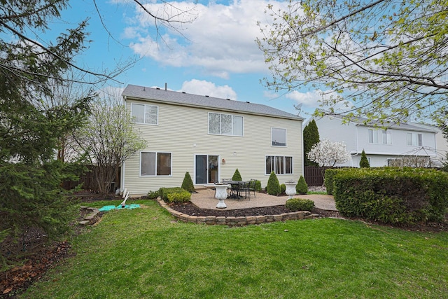 back of house featuring a lawn, fence, and a patio