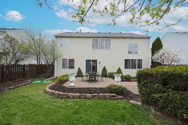 back of house featuring a patio, fence, and a lawn