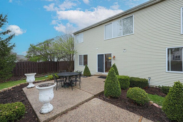 back of house featuring a patio and fence