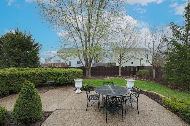 view of patio with fence and outdoor dining area