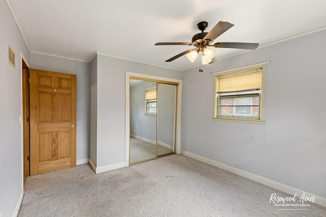 511 N Cleveland Ave, Bradley, IL 60915 - unfurnished bedroom with a closet, visible vents, light carpet, and multiple windows