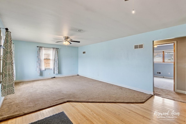 511 N Cleveland Ave, Bradley, IL 60915 - empty room with visible vents, carpet flooring, ceiling fan, and a healthy amount of sunlight
