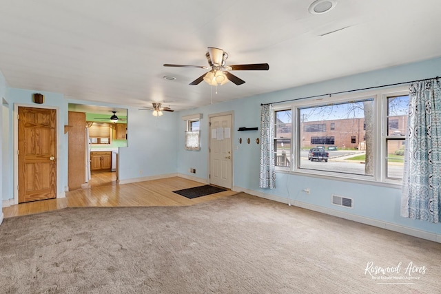 511 N Cleveland Ave, Bradley, IL 60915 - unfurnished living room featuring baseboards, a ceiling fan, visible vents, and carpet