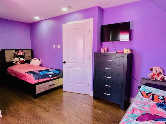bedroom with recessed lighting and wood finished floors