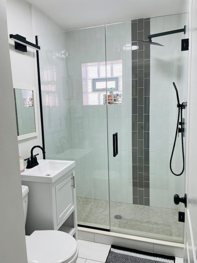 full bathroom featuring vanity, toilet, and a stall shower