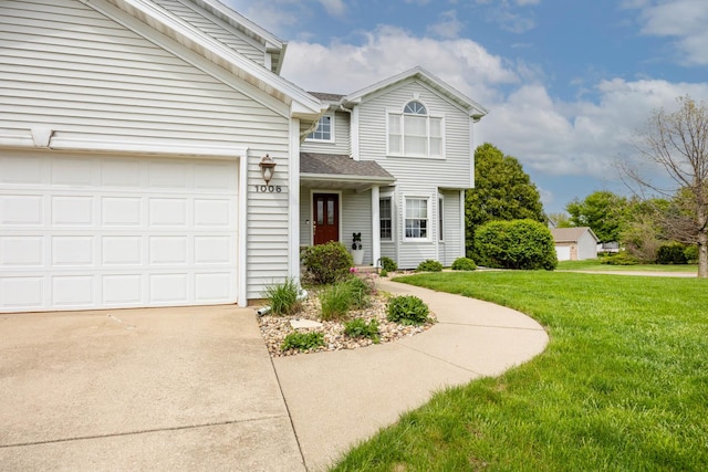 traditional-style house with roof with shingles, a garage, a front lawn, and driveway