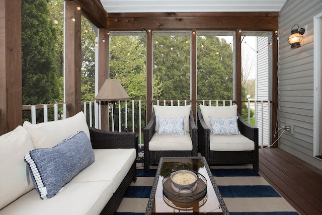 sunroom / solarium with an outdoor living space and a healthy amount of sunlight