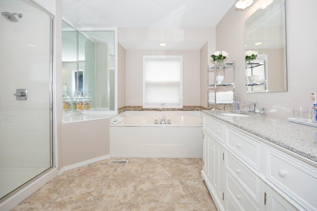 full bathroom with a stall shower, a garden tub, vanity, and visible vents