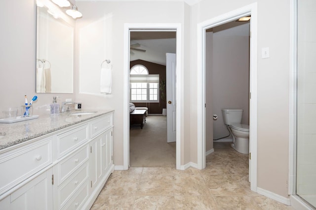 full bathroom with toilet, vanity, vaulted ceiling, connected bathroom, and baseboards