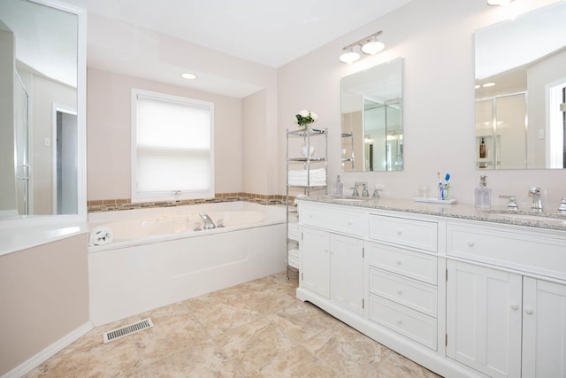 full bathroom featuring a stall shower, a garden tub, visible vents, and a sink