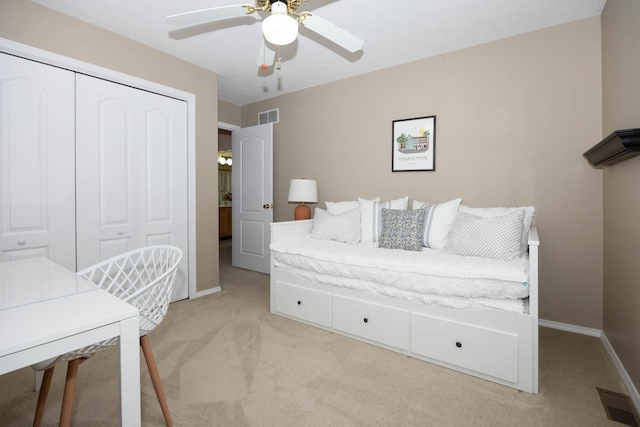 bedroom featuring baseboards, light carpet, and visible vents