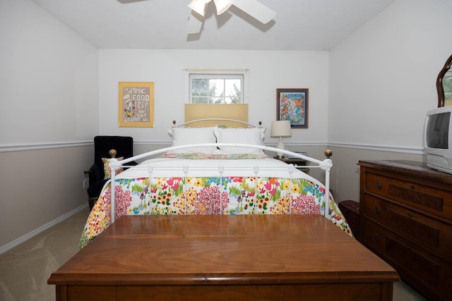 carpeted bedroom featuring baseboards and a ceiling fan