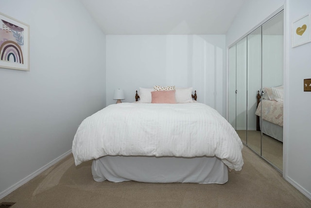 carpeted bedroom with baseboards and a closet