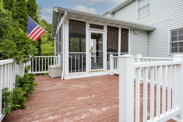 wooden deck with a sunroom