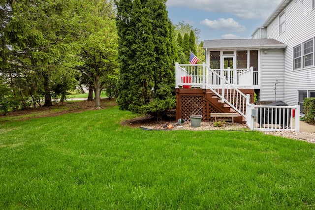 view of yard featuring stairs, a wooden deck, and a sunroom