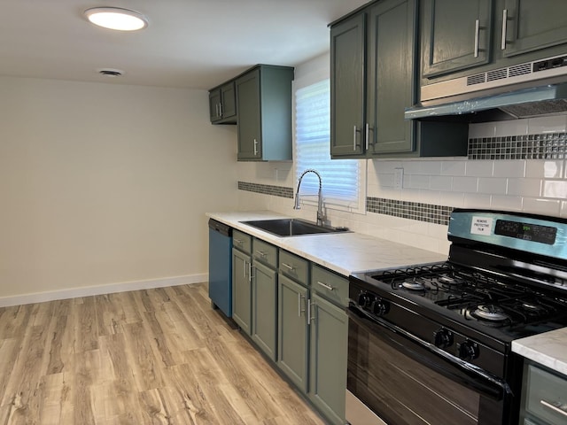 kitchen featuring a sink, black gas stove, light countertops, under cabinet range hood, and dishwasher