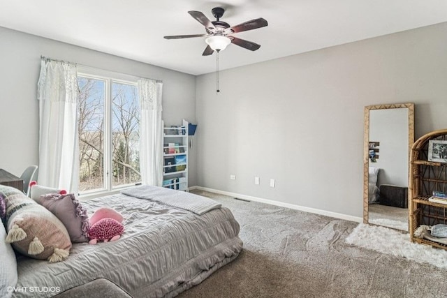 carpeted bedroom featuring baseboards, ceiling fan, and visible vents